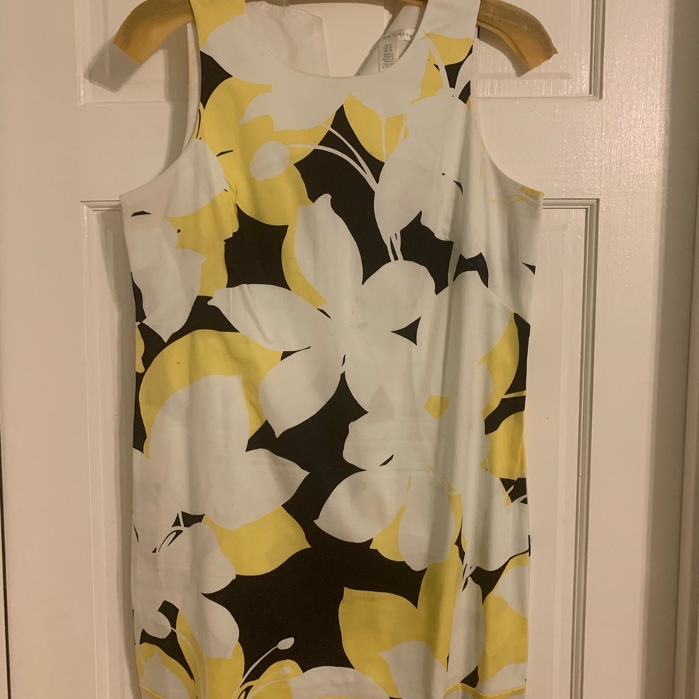 Gently used yellow and black on white background sleeveless dress